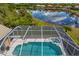 Inviting screened-in pool with a spa offering a private oasis and a view of the peaceful lake beyond at 10228 Estuary Dr, Tampa, FL 33647