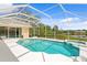 Inviting pool within a screened enclosure, offering lake views and a relaxing spa area at 10228 Estuary Dr, Tampa, FL 33647