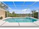 Enjoy the screened-in pool with stunning lake views, providing a private outdoor retreat at 10228 Estuary Dr, Tampa, FL 33647