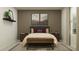 Stylish bedroom with a modern bed, decorative pillows, and plenty of natural light at 11959 Brae Way, Dade City, FL 33525