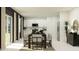 Dining room with modern table, chairs, stainless steel refrigerator, and sliding glass door at 11959 Brae Way, Dade City, FL 33525