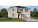 Inviting two-story home with a neutral color scheme, attached garage, and a well-manicured front yard at 11959 Brae Way, Dade City, FL 33525