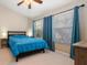 Bedroom featuring carpet, ceiling fan, windows, a bed, and two night stands at 12346 Country White Cir, Tampa, FL 33635