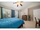 Bedroom with carpet, ceiling fan, windows, wooden dresser and exercise bike at 12346 Country White Cir, Tampa, FL 33635