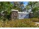 Stone community entrance sign for Country Chase Townhomes surrounded by lush landscaping and greenery at 12346 Country White Cir, Tampa, FL 33635