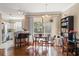 Sunlit dining area with hardwood floors, adjacent to an open kitchen at 12346 Country White Cir, Tampa, FL 33635