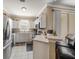 Modern kitchen with stainless steel appliances, white cabinets, and a breakfast bar at 12346 Country White Cir, Tampa, FL 33635