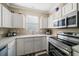 Bright kitchen featuring white cabinets, stainless steel appliances, and ample counter space at 12346 Country White Cir, Tampa, FL 33635