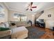 Bright living room with hardwood floors, large sofa and entertainment center at 12346 Country White Cir, Tampa, FL 33635