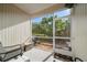 Enclosed patio sitting area with view of greenery and a welcome mat at 12346 Country White Cir, Tampa, FL 33635
