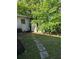Backyard with stone walkway leading to shed at 1448 Lemon St, Clearwater, FL 33756