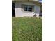 Side yard of home with grass and a hose at 1448 Lemon St, Clearwater, FL 33756