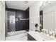 Contemporary bathroom featuring a shower-tub combo with stylish black tile, and a vanity at 18187 Paradise Point Dr, Tampa, FL 33647