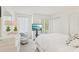 Bright bedroom with large windows, a comfortable bed, and dresser at 18187 Paradise Point Dr, Tampa, FL 33647