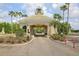 Exterior shot of the community gate with a decorative tower and lush landscaping at 18187 Paradise Point Dr, Tampa, FL 33647