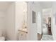 Hallway view including a half bathroom, hardwood floors, and an arched doorway at 18187 Paradise Point Dr, Tampa, FL 33647