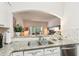 Open concept kitchen with granite countertops, stainless steel appliances, and view to the living room at 18187 Paradise Point Dr, Tampa, FL 33647