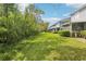 Lush green backyard adjacent to wooded area provides privacy for this home at 18187 Paradise Point Dr, Tampa, FL 33647