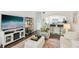 Cozy living room showcasing modern decor, a large TV, and an open view to the kitchen at 18187 Paradise Point Dr, Tampa, FL 33647