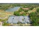 Aerial view of the community tennis courts next to a pond and wooded area at 18187 Paradise Point Dr, Tampa, FL 33647