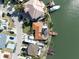 Aerial view of waterfront homes with boat docks and boats on the canal at 187 175Th Terrace E Dr, Redington Shores, FL 33708