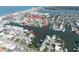 Aerial view of waterfront homes surrounded by canals and waterways, with beaches and ocean in the distance at 187 175Th Terrace E Dr, Redington Shores, FL 33708