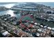 Aerial view showcasing beautiful homes along a tranquil waterway with private boat docks in a lovely residential area at 187 175Th Terrace E Dr, Redington Shores, FL 33708