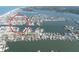 Aerial view captures a community of homes nestled along waterways, complete with private boat docks for waterfront living at 187 175Th Terrace E Dr, Redington Shores, FL 33708