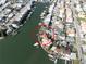 An aerial view of a waterfront home encircled within a community on a narrow waterway at 187 175Th Terrace E Dr, Redington Shores, FL 33708