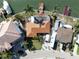 Aerial view of waterfront homes with boat docks, a private deck, and a well-kept lawn at 187 175Th Terrace E Dr, Redington Shores, FL 33708