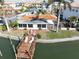 Waterfront home boasting a private dock, lounge chairs, and manicured backyard offering a relaxing retreat at 187 175Th Terrace E Dr, Redington Shores, FL 33708