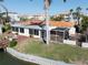 Exterior view of the home featuring a screened in lanai, and spacious backyard near the waterfront at 187 175Th Terrace E Dr, Redington Shores, FL 33708