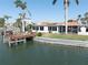 Enjoy waterfront living with a private dock, spacious yard, and serene views from this beautiful home at 187 175Th Terrace E Dr, Redington Shores, FL 33708
