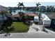 Charming waterfront home featuring a tile roof, lush landscaping, and a spacious driveway for RV parking at 187 175Th Terrace E Dr, Redington Shores, FL 33708