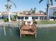 Waterfront home with private dock and seating, overlooking the tranquil canal waters at 187 175Th Terrace E Dr, Redington Shores, FL 33708