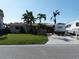 Well-maintained home with lush front lawn and convenient RV parking in the driveway, under a clear blue sky at 187 175Th Terrace E Dr, Redington Shores, FL 33708