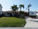 Charming home featuring a well-manicured lawn and ample RV parking space in the driveway at 187 175Th Terrace E Dr, Redington Shores, FL 33708