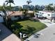 Home with RV parking, lush green lawn, and palm trees with waterfront access nearby at 187 175Th Terrace E Dr, Redington Shores, FL 33708