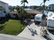 Well-maintained home features a green lawn, RV parking, and nearby waterfront views at 187 175Th Terrace E Dr, Redington Shores, FL 33708