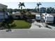 Charming home with a tile roof, lush green lawn, and RV parking on a sunny day at 187 175Th Terrace E Dr, Redington Shores, FL 33708