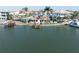 Expansive waterfront view of a home with a private dock, lush surroundings, and serene water setting at 187 175Th Terrace E Dr, Redington Shores, FL 33708