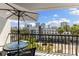 This balcony features an umbrella covered table with a view of the city skyline at 201 W Laurel St # 702, Tampa, FL 33602