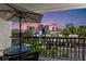 Balcony view showcasing a table with umbrella and the cityscape during a vibrant sunset at 201 W Laurel St # 702, Tampa, FL 33602