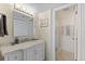 Bathroom featuring a vanity, mirror, and glass door shower at 201 W Laurel St # 702, Tampa, FL 33602