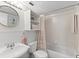 This bathroom provides a tub with a shower and storage with a flamingo theme at 201 W Laurel St # 702, Tampa, FL 33602