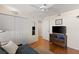 This bedroom offers hardwood floors, a ceiling fan, closet, and flatscreen television at 201 W Laurel St # 702, Tampa, FL 33602