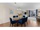 An open-concept living space with a dining area with hardwood floors and light-filled balcony access at 201 W Laurel St # 702, Tampa, FL 33602
