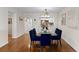Dining room with hardwood floors, a glass table, and seating for six, connecting to the kitchen at 201 W Laurel St # 702, Tampa, FL 33602