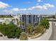 A full exterior view of the building with a lot of balconies and lush, tropical landscaping surrounding the property at 201 W Laurel St # 702, Tampa, FL 33602