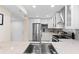 Bright kitchen featuring white cabinets, stainless steel appliances, and attractive backsplash at 201 W Laurel St # 702, Tampa, FL 33602